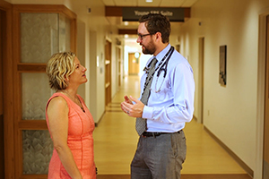 Dr. Word speaks with a patient at the Cowell Family Cancer Center