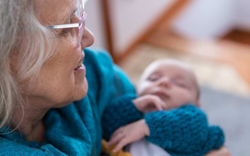 Older woman holding infant