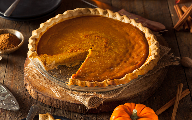 warm pumpkin pie with a slice cut out