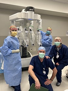 Dr. McKerchie, Zach Hopkins, RN, Shylee Kintigh, CST, and Denise Montgomery, CRNA of Munson Healthcare Charlevoix Hospital pictured in front of the Da Vinci XI Surgical System