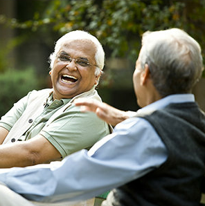 two older men laughing outside