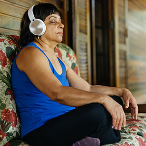woman meditating with headphones on