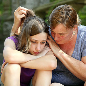 mother comforting an upset daughter