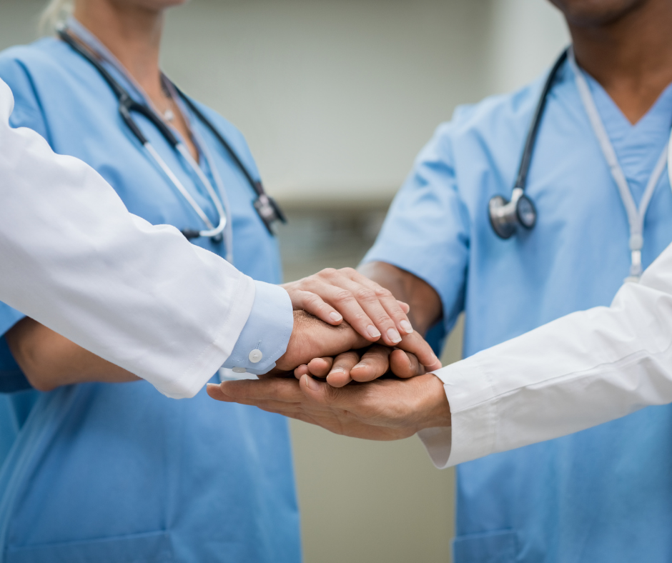 doctors stack hands in support of munson healthcare hospitals