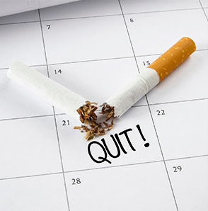 a calendar with I Quit and a broken cigarette on it